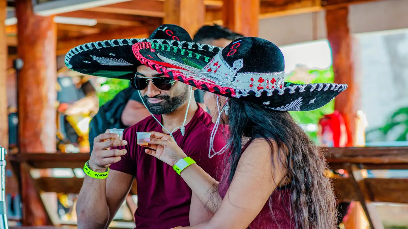 A young couple enjoys a tequila tasting in the Cancun lagoon.